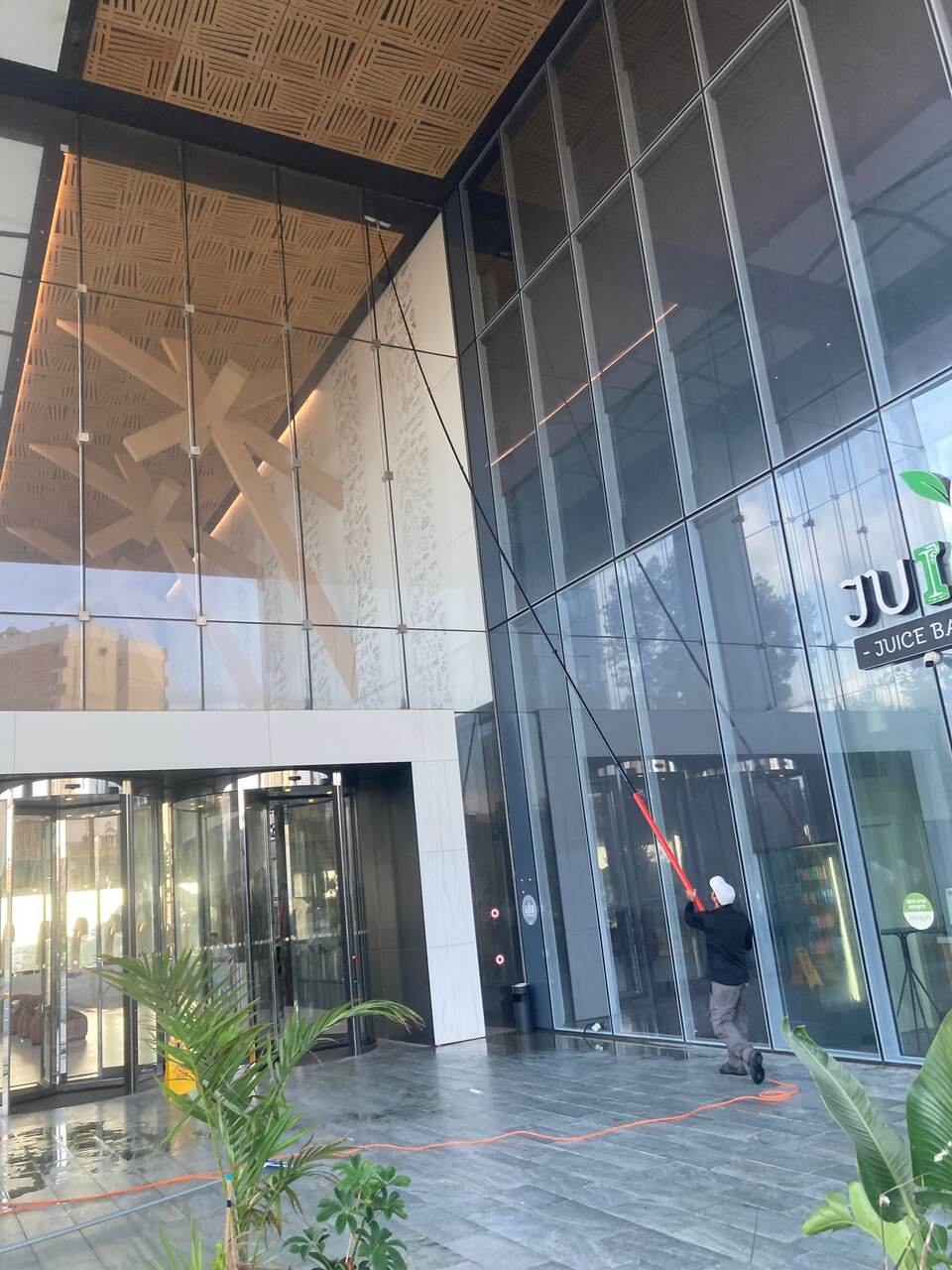 עובד סנפלינג מתקן צינור ניקוז חיצוני בקומה גבוהה